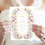 Wedding Invitation with wildflower design held by the bride thumbnail image