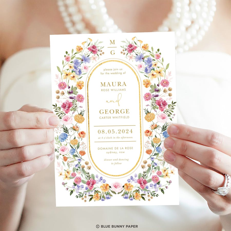 Wedding Invitation with wildflower design held by the bride